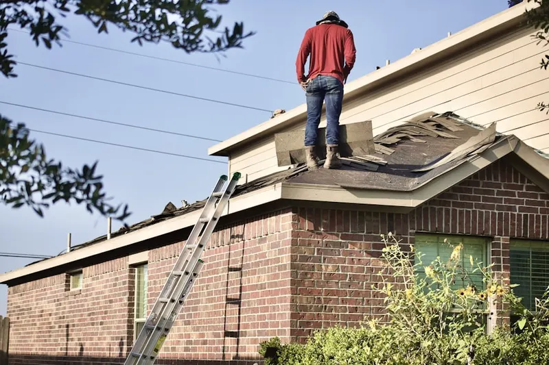 Professional roofer working on a residential roof in Montezuma